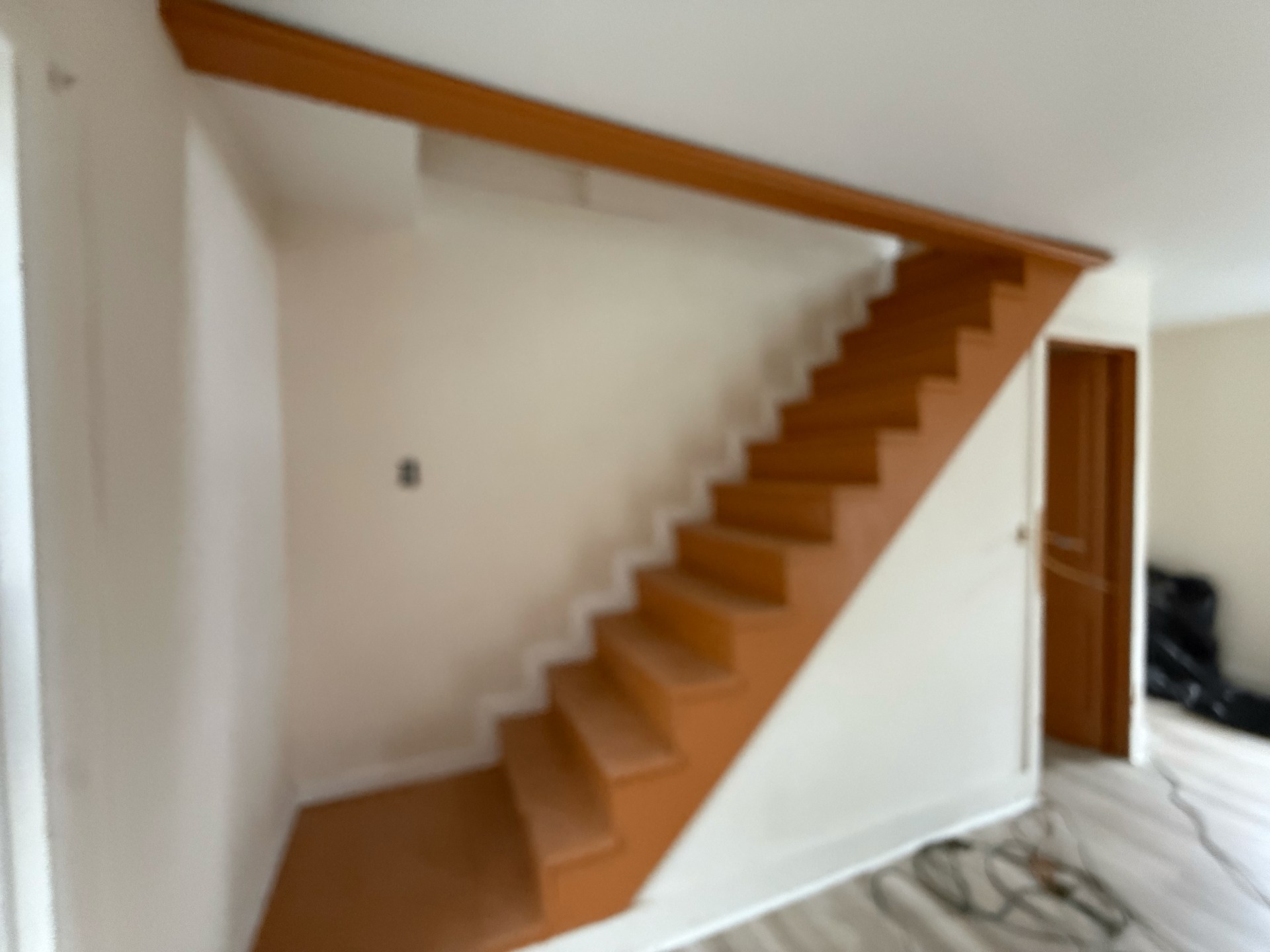 Finished interior staircase with fresh stain and a clean modern look after renovation