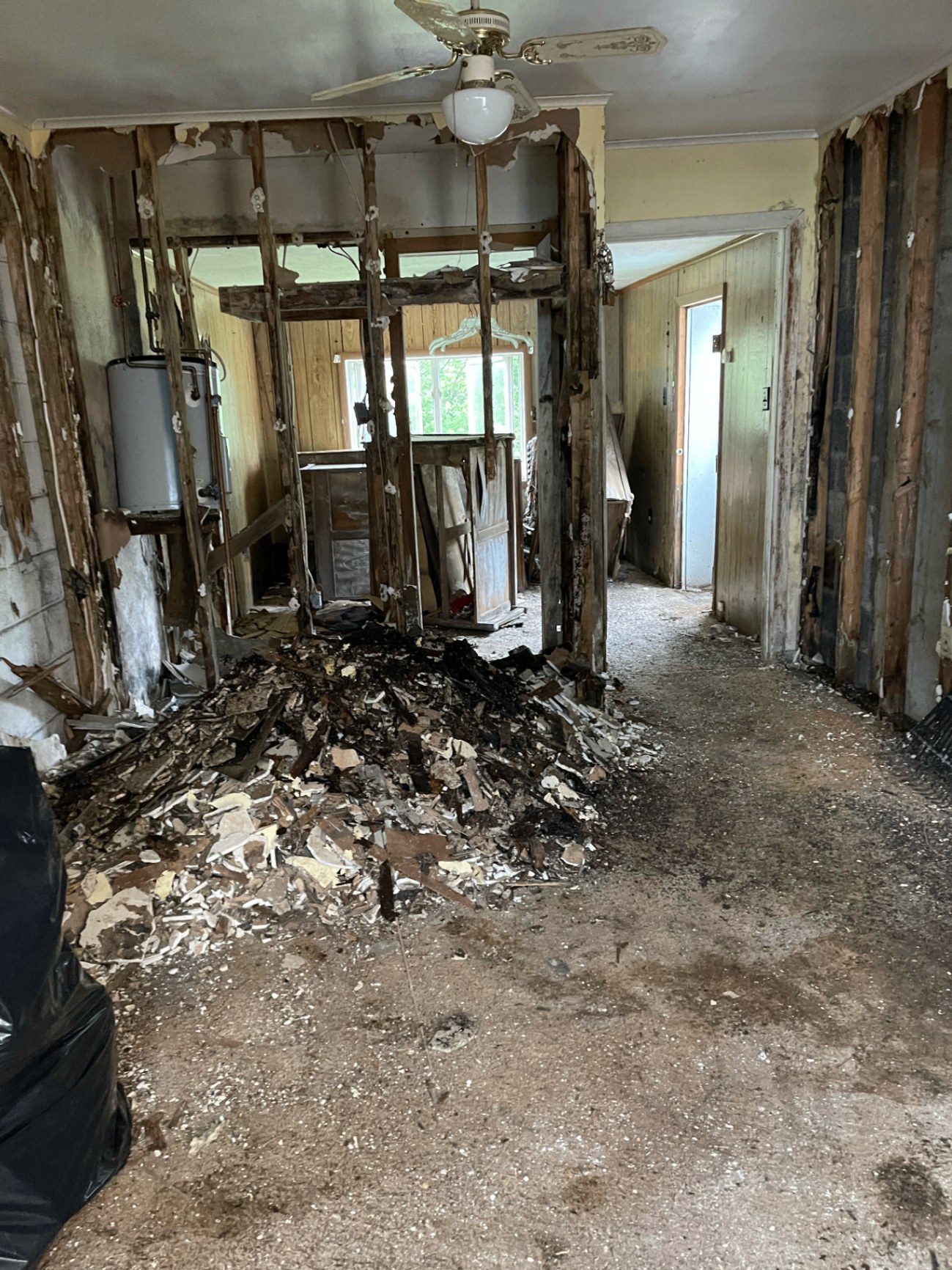 Kitchen during major tear-out with exposed framing and debris removal