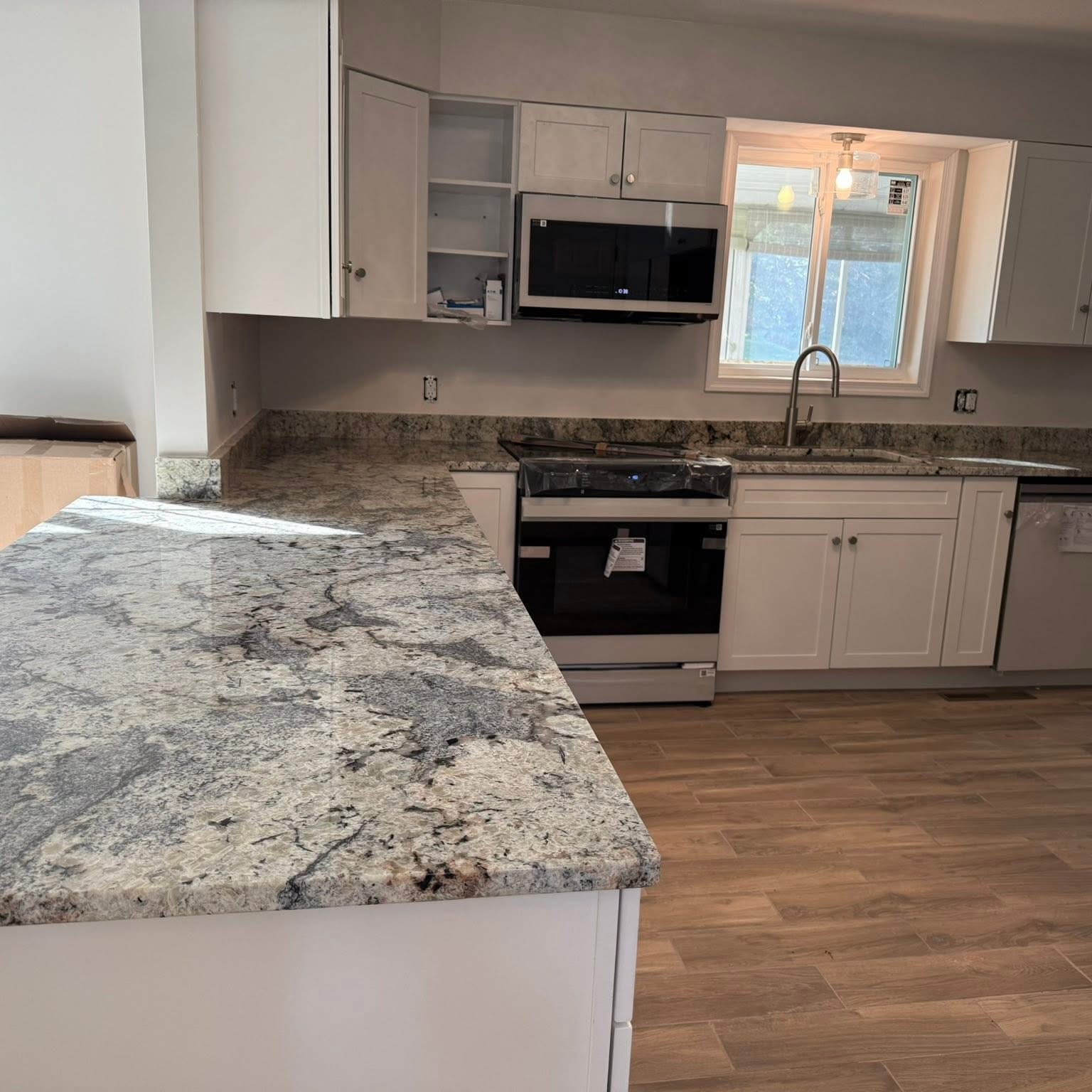 Finished kitchen remodel — bright modern space with new flooring and cabinetry