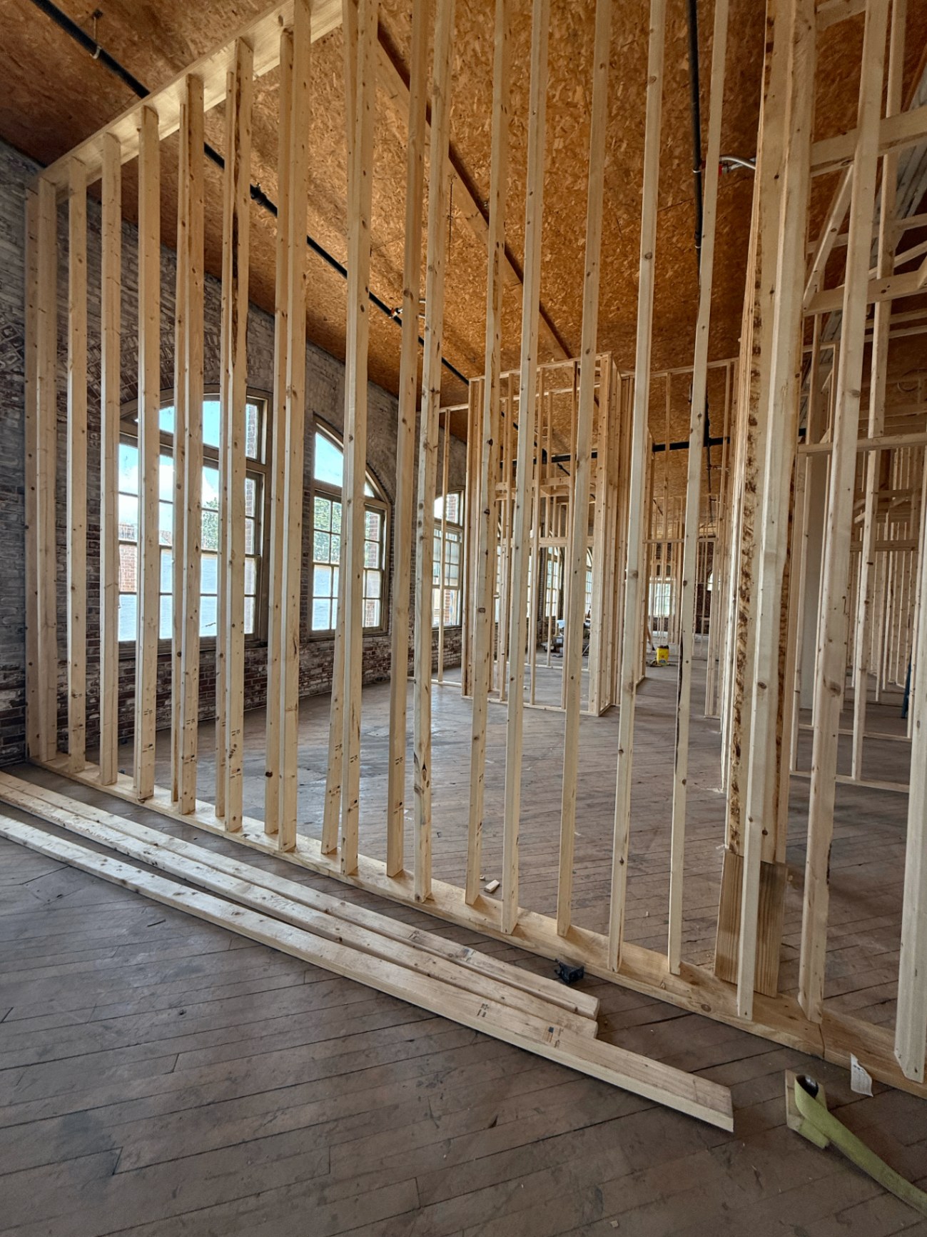 Interior framing for a full building renovation with new floor joists and window openings